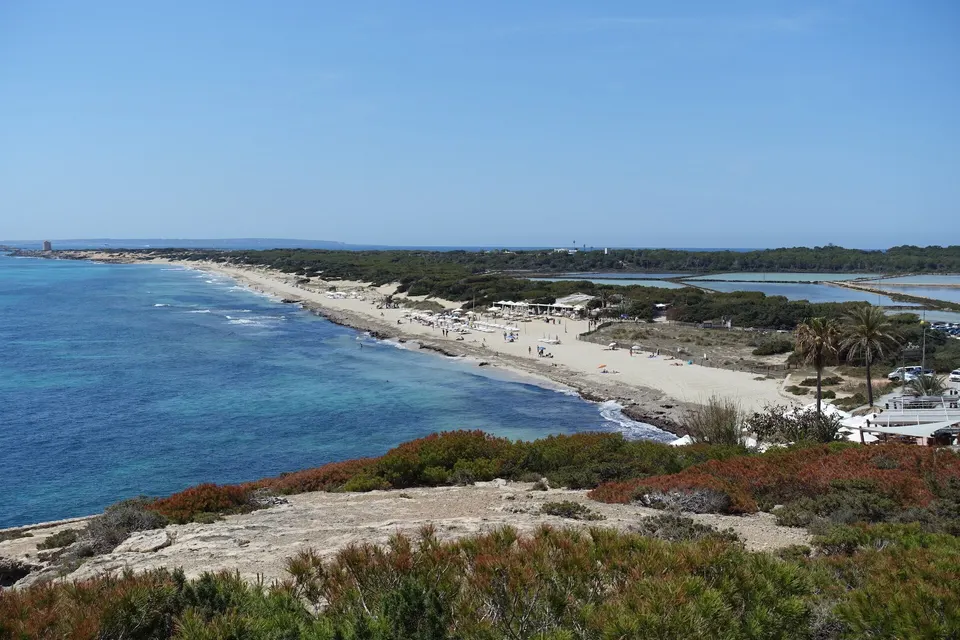 Es Cavallet beach and the Ses Salines salt pans seen from the headland